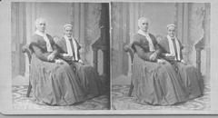 SA0011 - Polly Lewis is on the right with Anne Liza Charles on the left. Both are seated in chairs for a studio photograph. Caption on the back., Winterthur Shaker Photograph and Post Card Collection 1851 to 1921c